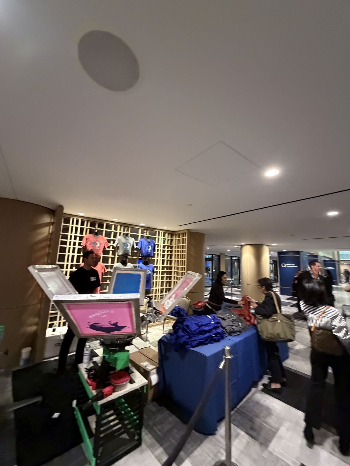 Guests watching custom merch get printed live at an Oklahoma City event